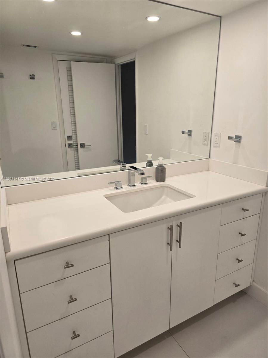 1121 Crandon Boulevard, Unit D604 Key Biscayne, FL 33149 - Photo 12 of 31 a bathroom with a sink and a mirror