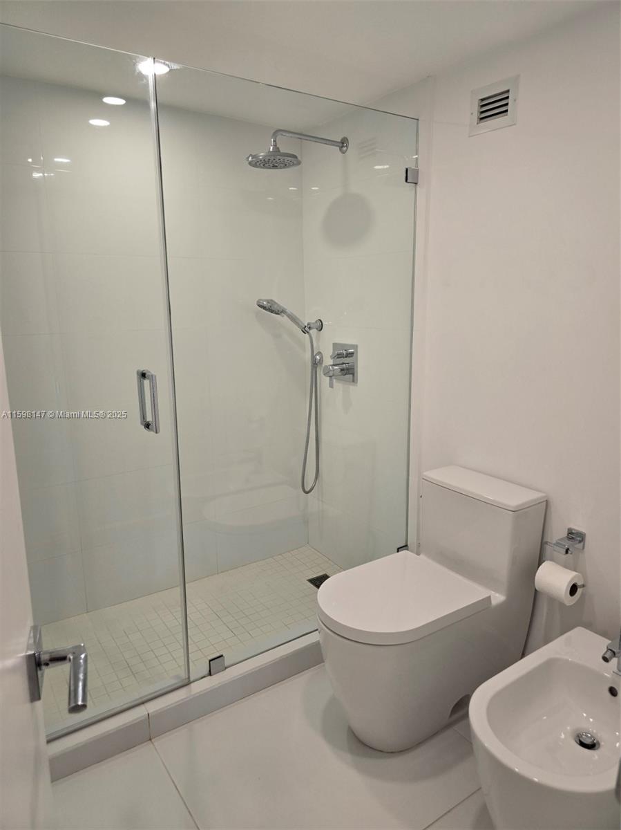 1121 Crandon Boulevard, Unit D604 Key Biscayne, FL 33149 - Photo 13 of 31 a bathroom with a toilet and a shower
