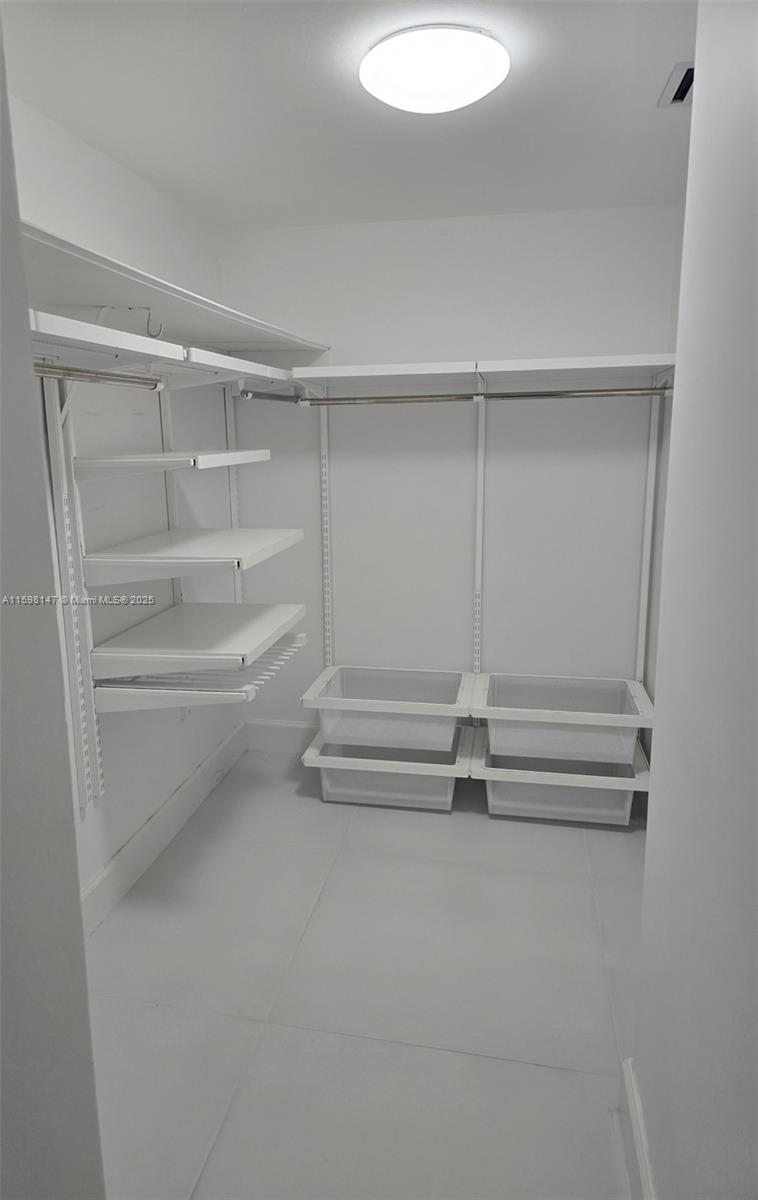 1121 Crandon Boulevard, Unit D604 Key Biscayne, FL 33149 - Photo 14 of 31 a view of walk in closet with empty racks