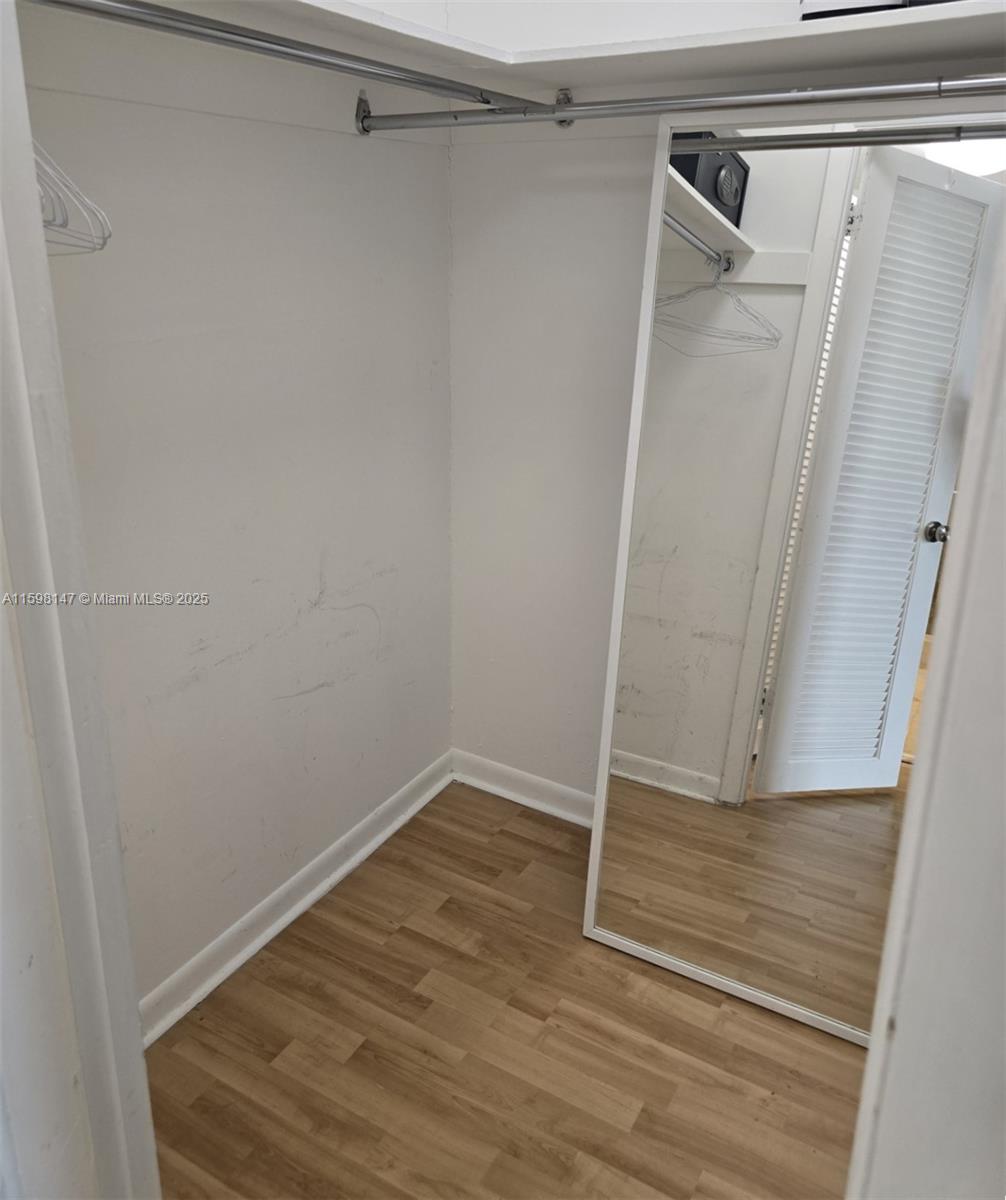 1121 Crandon Boulevard, Unit D604 Key Biscayne, FL 33149 - Photo 18 of 31 a view of walk in closet with wooden floor