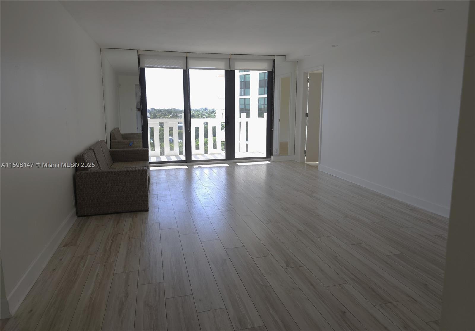1121 Crandon Boulevard, Unit D604 Key Biscayne, FL 33149 - Photo 2 of 31 a living room with furniture and a large window