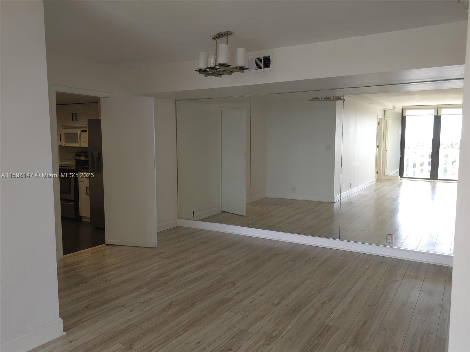 1121 Crandon Boulevard, Unit D604 Key Biscayne, FL 33149 - Photo 4 of 31 wooden floor in an empty room with a window