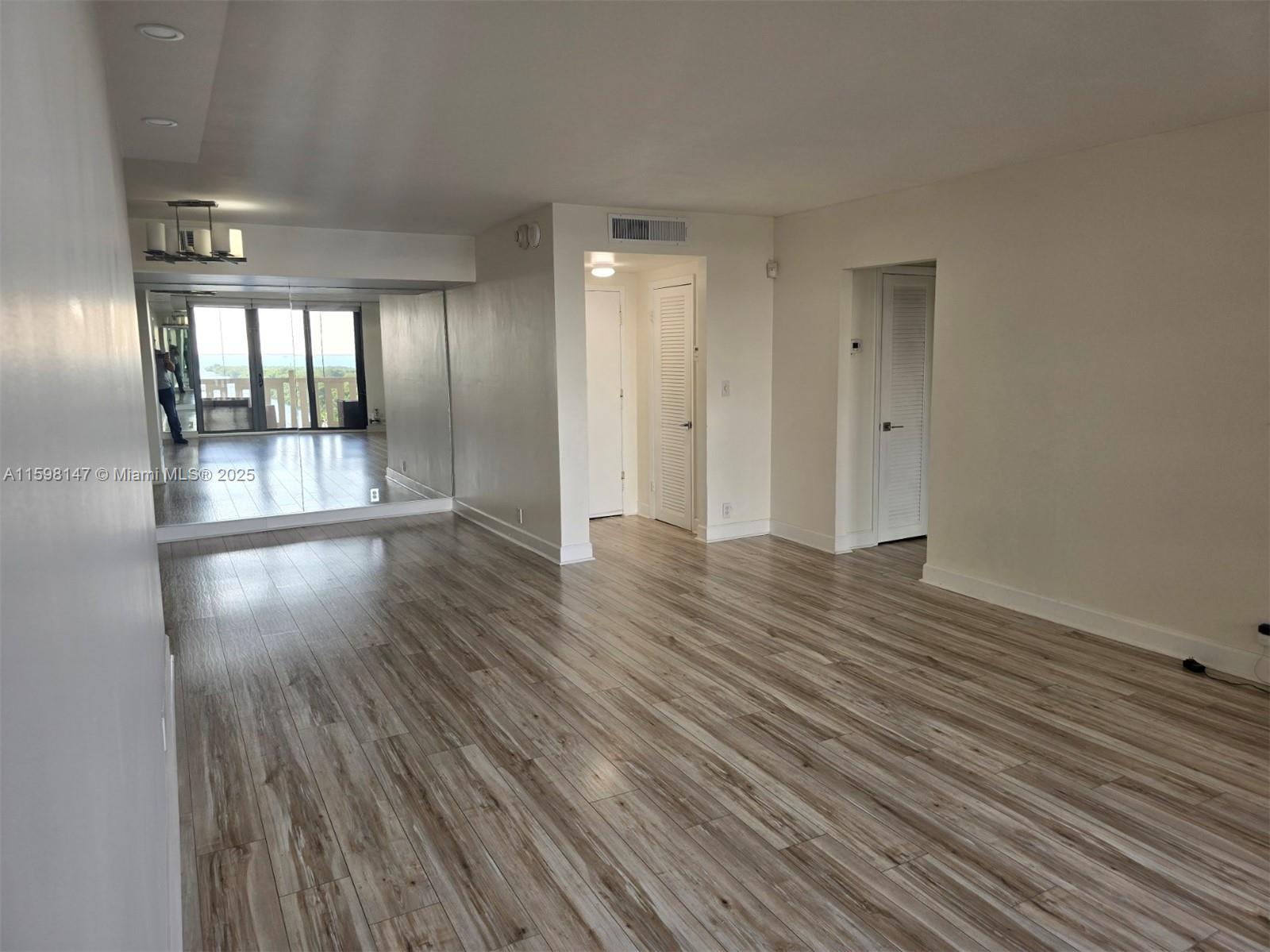 1121 Crandon Boulevard, Unit D604 Key Biscayne, FL 33149 - Photo 6 of 31 wooden floor in an empty room with a window