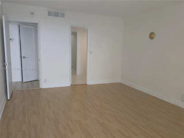 a view of an empty room and wooden floor