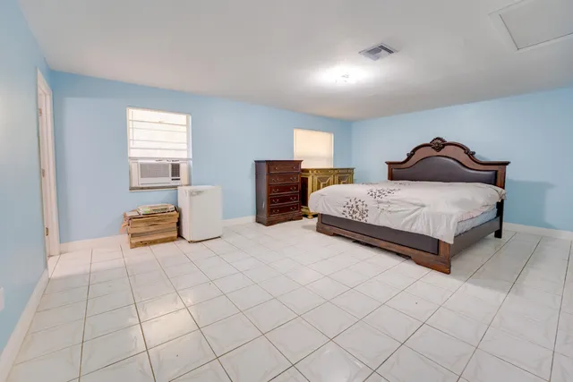 a spacious bedroom with a bed and window