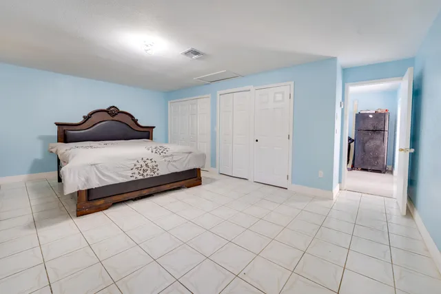 a bedroom with a bed and a lamp