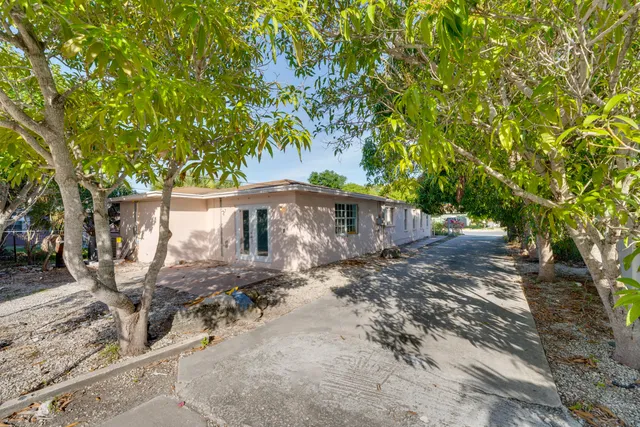 a view of a house with large trees
