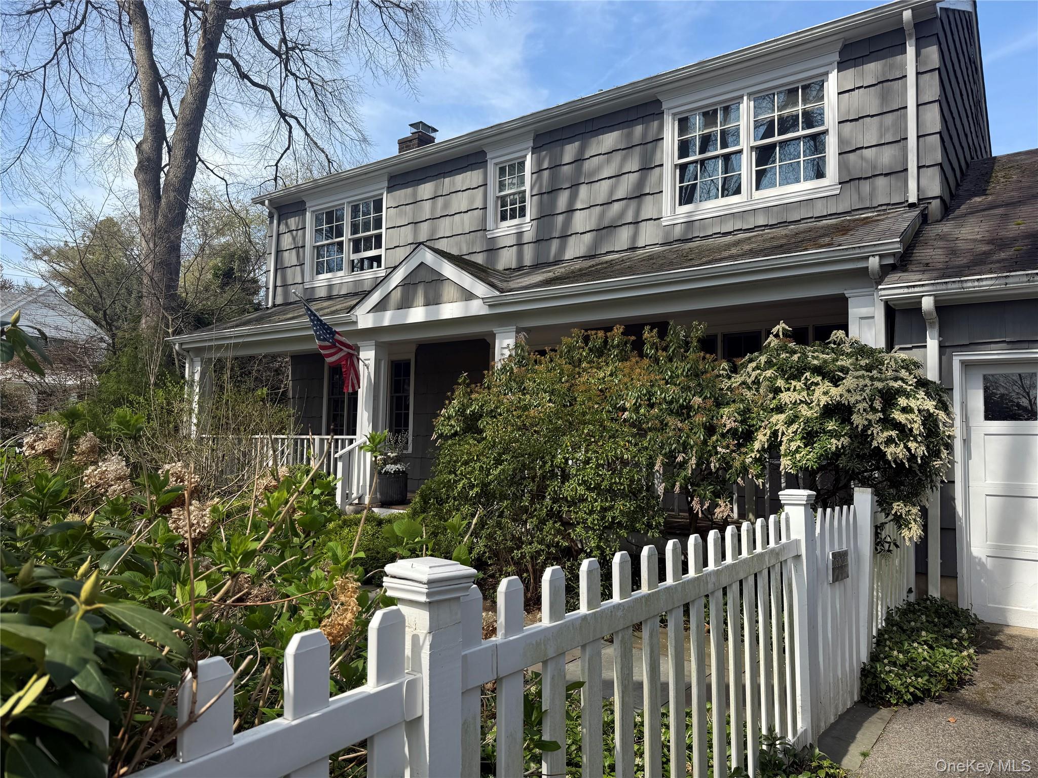 21 Westbank Road Rye, NY 10580 - Photo 1 of 32 a front view of a house with a garden