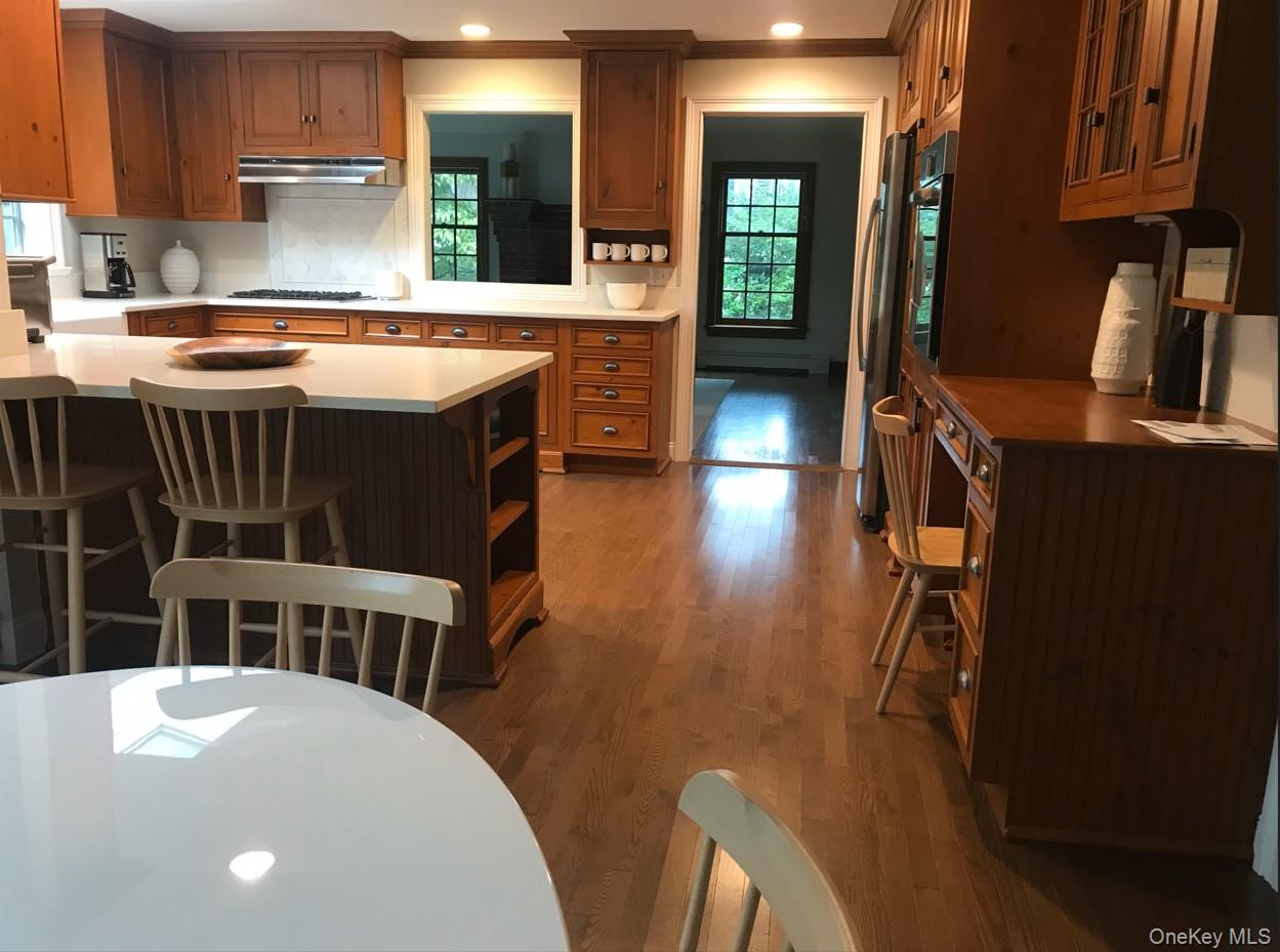 21 Westbank Road Rye, NY 10580 - Photo 5 of 32 a kitchen that has a table chairs in it and wooden floors