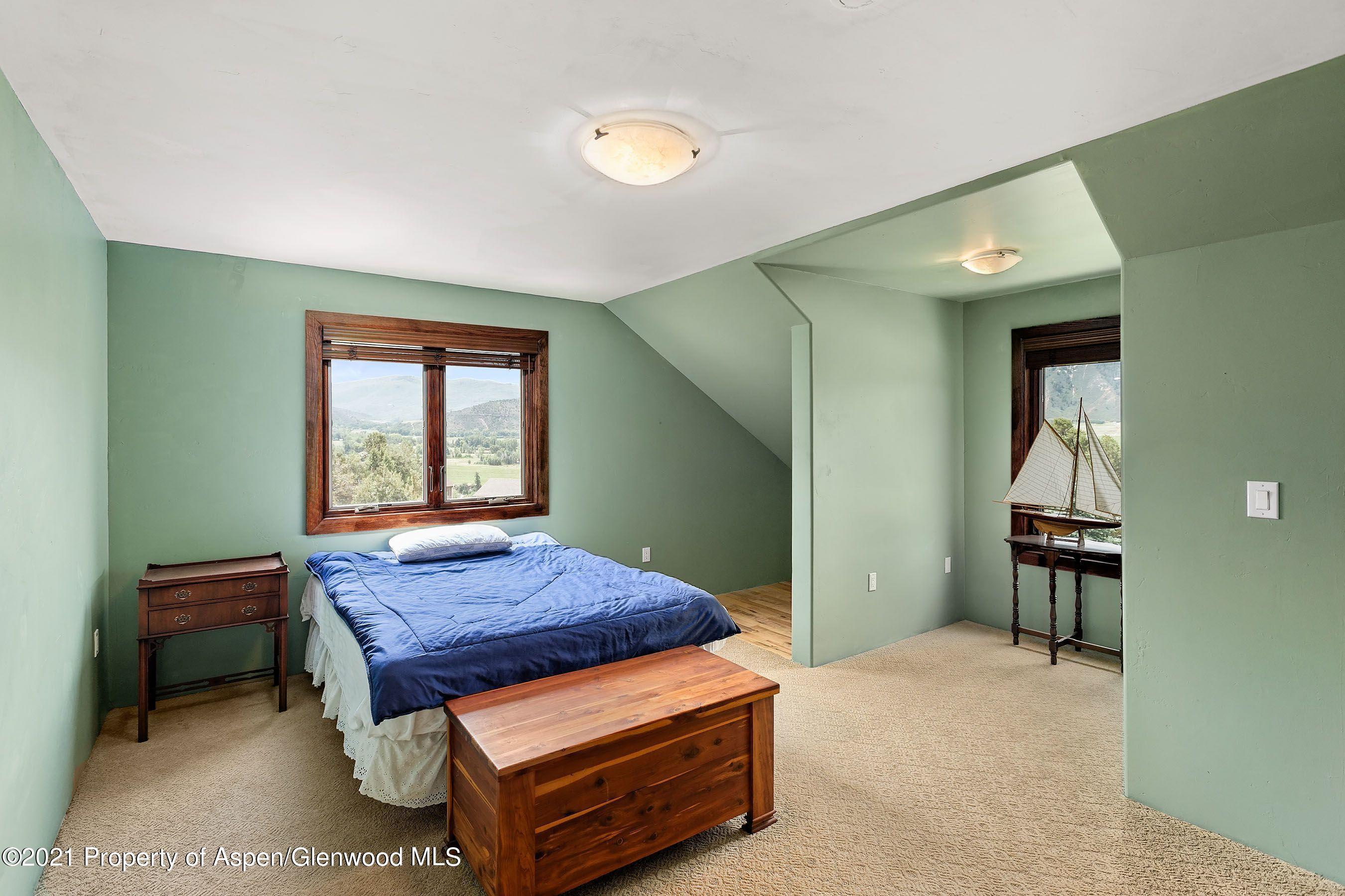 461 Original Road Basalt, CO 81621 - Photo 13 of 23 a bedroom with a bed and a dresser in it