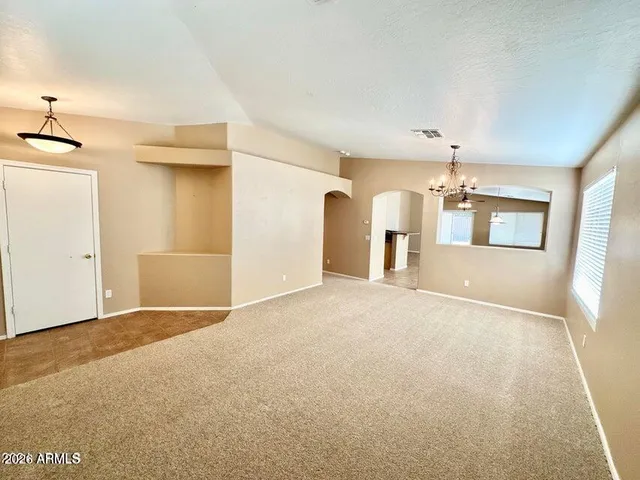 an empty room with a empty space and windows