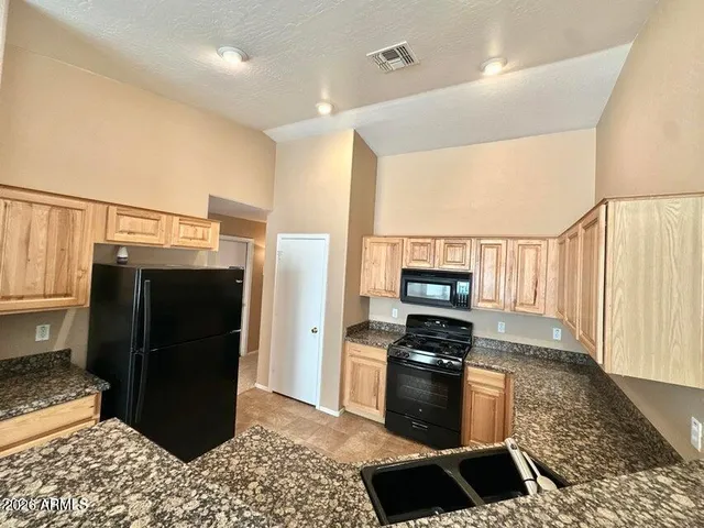 a kitchen with a refrigerator and a stove