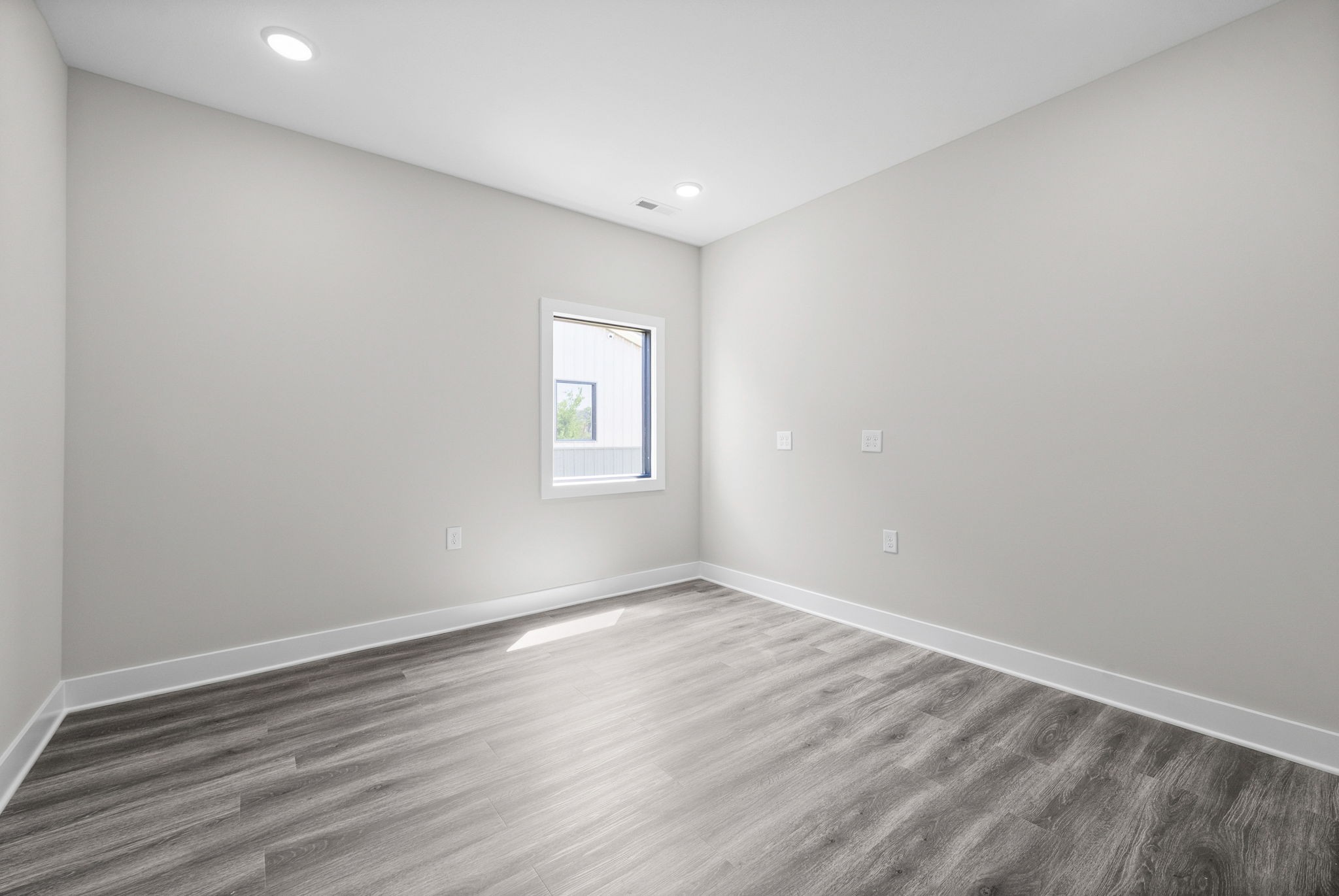 2510 Pea Ridge Road Clarksville, TN 37040 - Photo 17 of 40 an empty room with wooden floor and windows