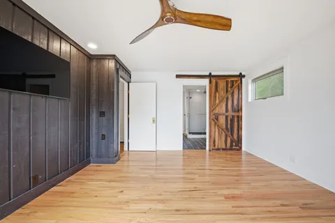 a bedroom with a large bed and a window