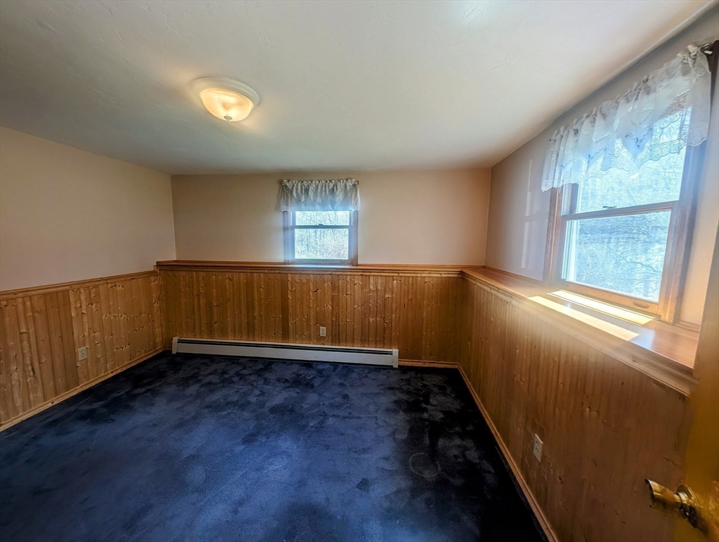 4 Hammerock Road Charlton, MA 01507 - Photo 12 of 39 an empty room with wooden floor and windows