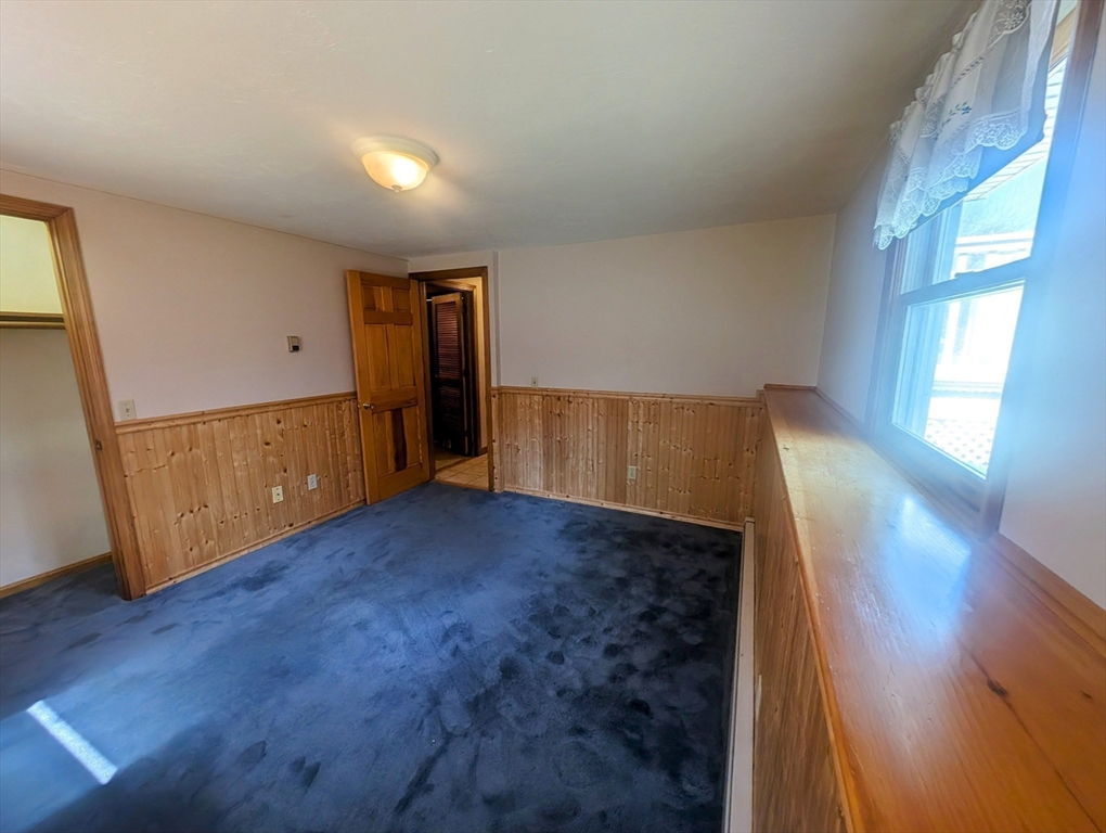 4 Hammerock Road Charlton, MA 01507 - Photo 13 of 39 a view of an empty room with wooden floor and a window