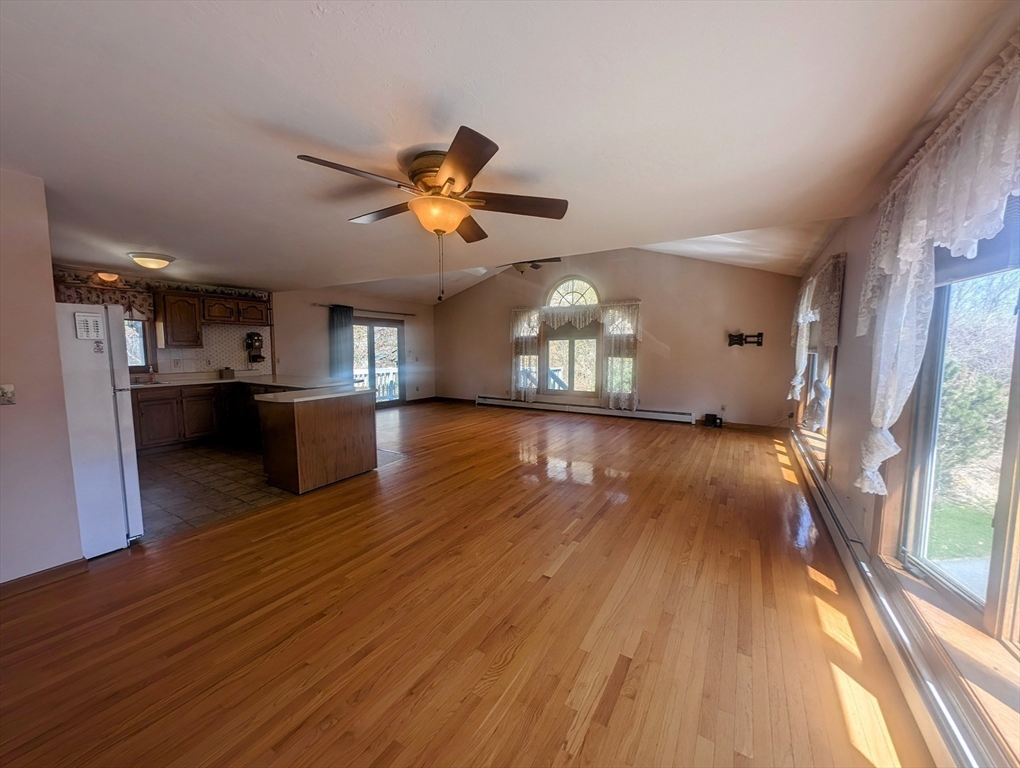 4 Hammerock Road Charlton, MA 01507 - Photo 18 of 39 a view of a big room with wooden floor and a kitchen