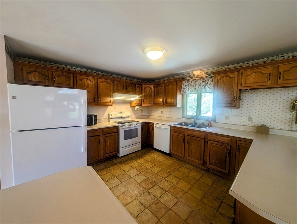 4 Hammerock Road Charlton, MA 01507 - Photo 19 of 39 a kitchen with a sink a refrigerator and cabinets