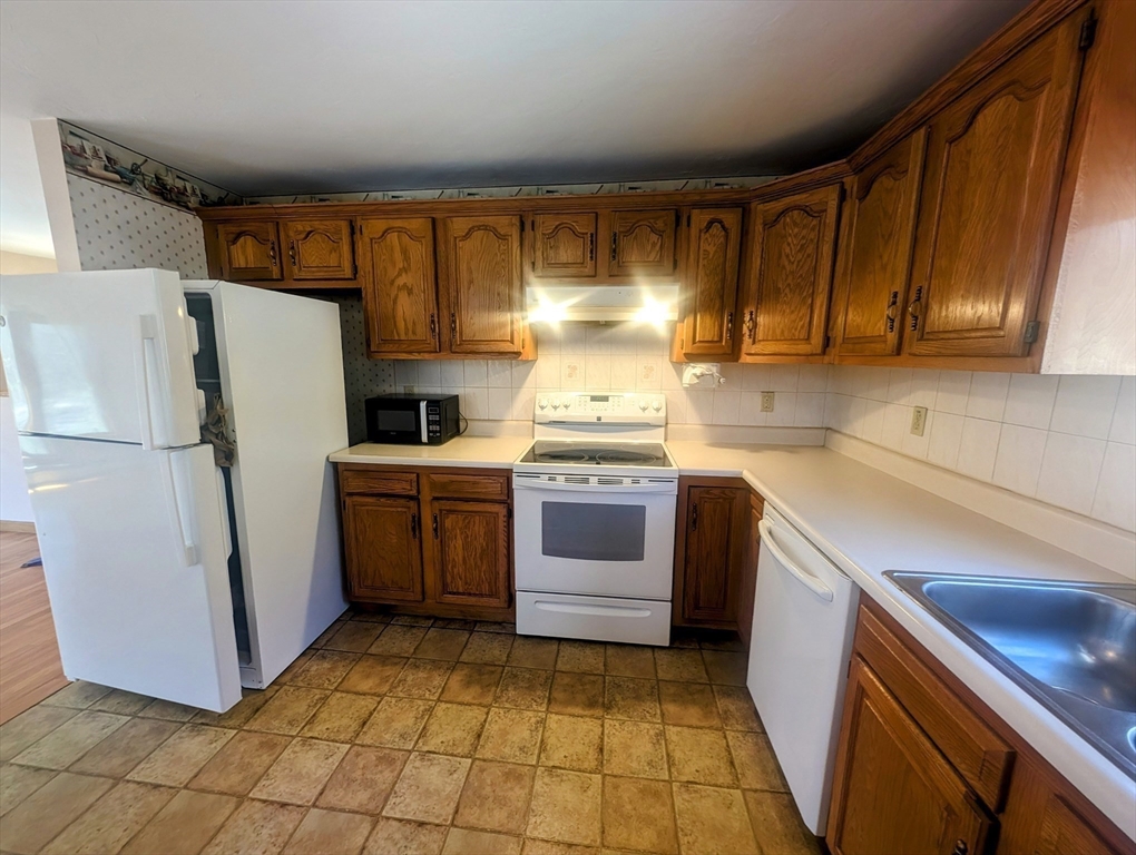 4 Hammerock Road Charlton, MA 01507 - Photo 21 of 39 a kitchen with a refrigerator sink and cabinets
