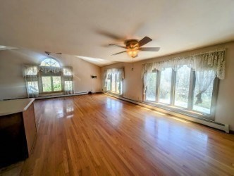 4 Hammerock Road Charlton, MA 01507 - Photo 3 of 39 a view of an empty room with wooden floor and a window