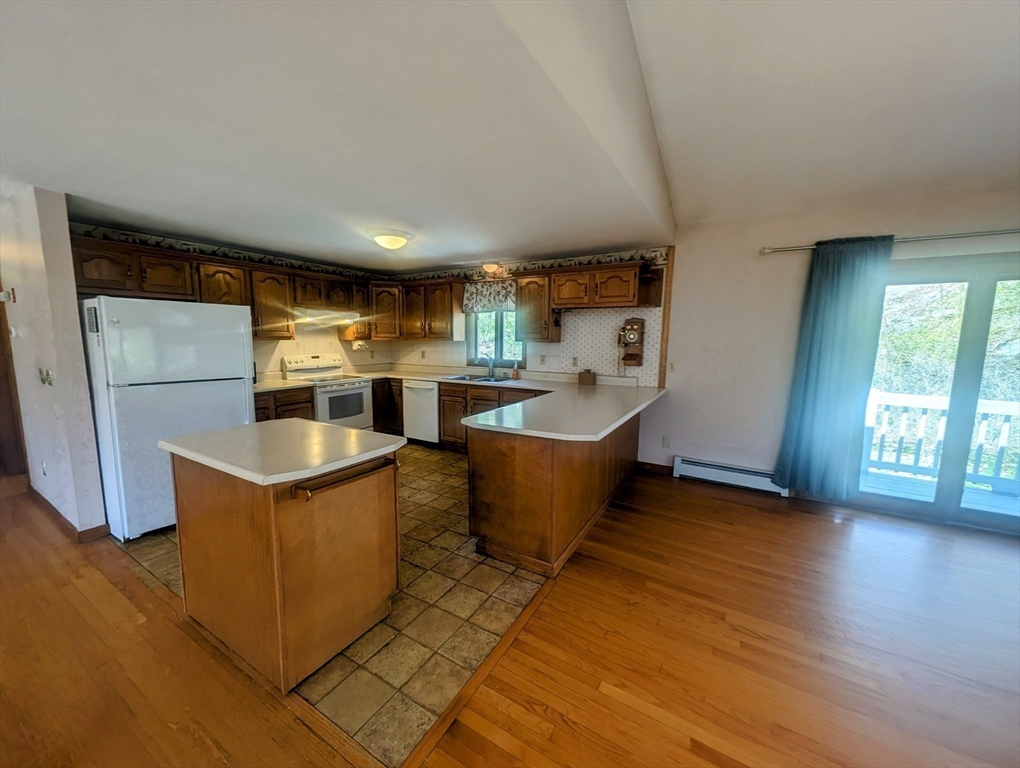 4 Hammerock Road Charlton, MA 01507 - Photo 6 of 39 a kitchen with stainless steel appliances granite countertop a refrigerator a sink dishwasher a stove and a dining table with wooden floor