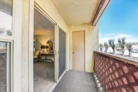 a view of a living room and a balcony