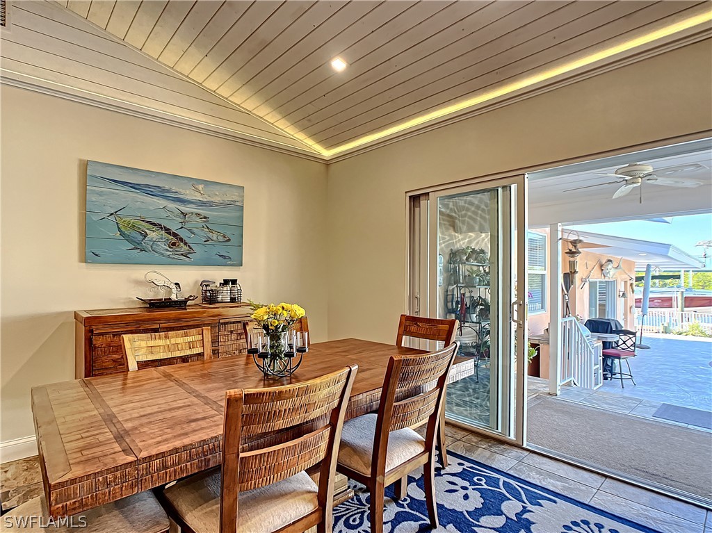 8065 Lagoon Road Fort Myers Beach, FL 33931 - Photo 16 of 28 a dining room with furniture and wooden floor