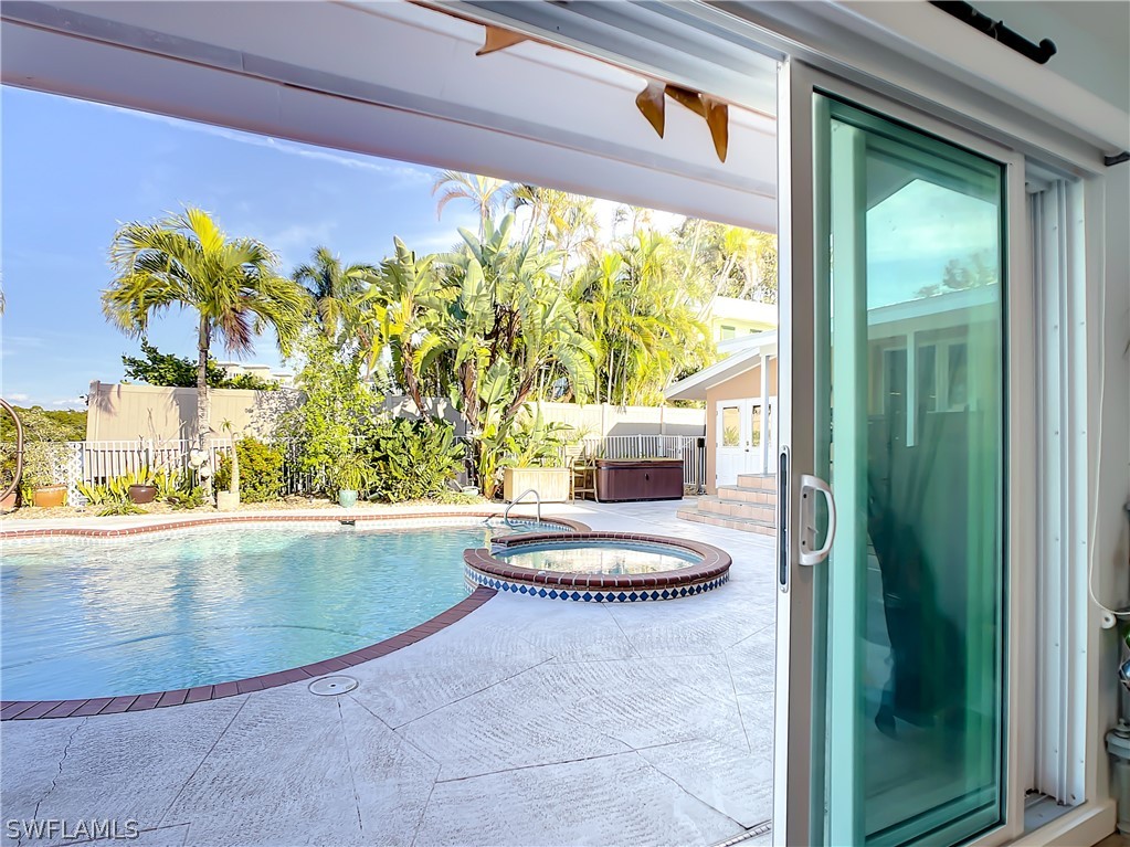 8065 Lagoon Road Fort Myers Beach, FL 33931 - Photo 24 of 28 a view of a swimming pool and window