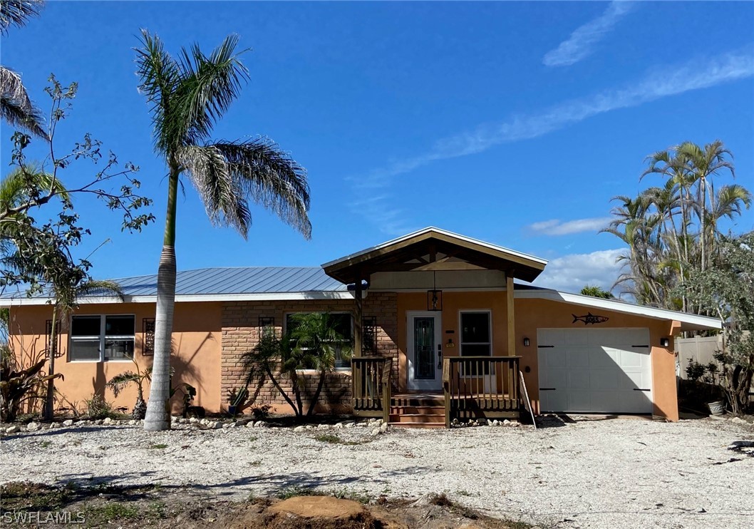8065 Lagoon Road Fort Myers Beach, FL 33931 - Photo 5 of 28 a front view of a house with patio