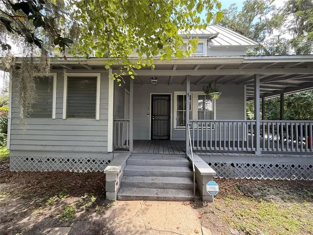 a view of a house with wooden fence