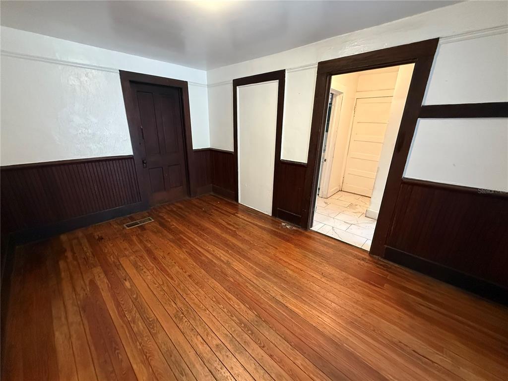 2523 Northwest 6th Street, Unit 1 Gainesville, FL 32609 - Photo 4 of 7 wooden floor in an empty room with a window