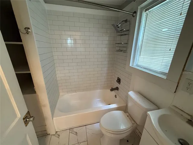 a bathroom with a toilet and a bathtub