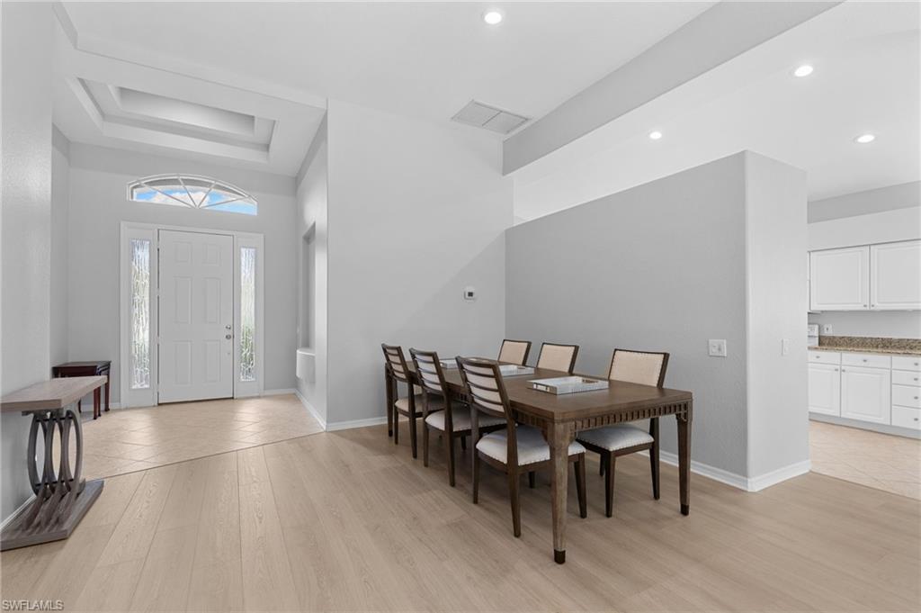 1717 Winding Oaks Way Naples, FL 34109 - Photo 5 of 29 a view of a dining room with furniture and wooden floor