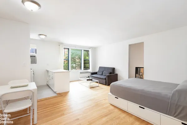 a bedroom with two beds and a large window