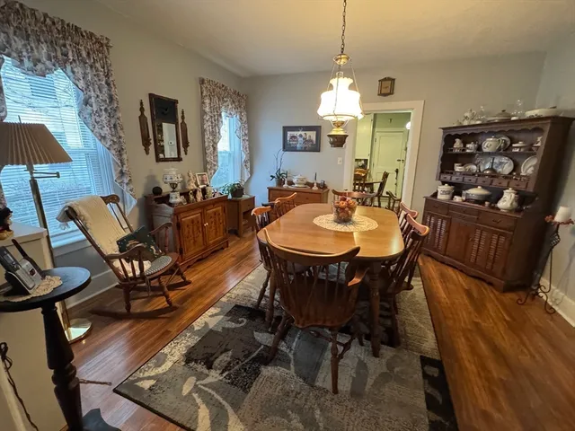a view of a dining room with furniture and chandelier