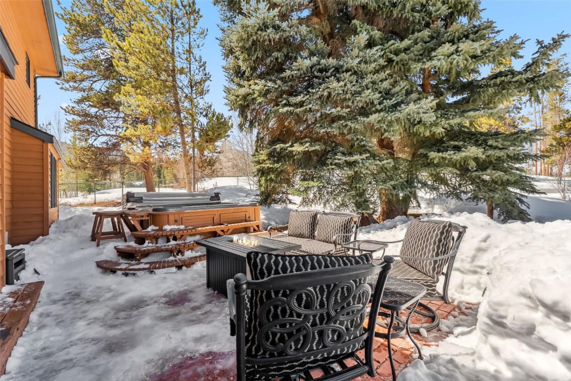 30 Grey Fox Lane Dillon, CO 80435 - Photo 45 of 50 Back patio with fire table, hot tub, picnic table, storage shed, and fenced-in yard