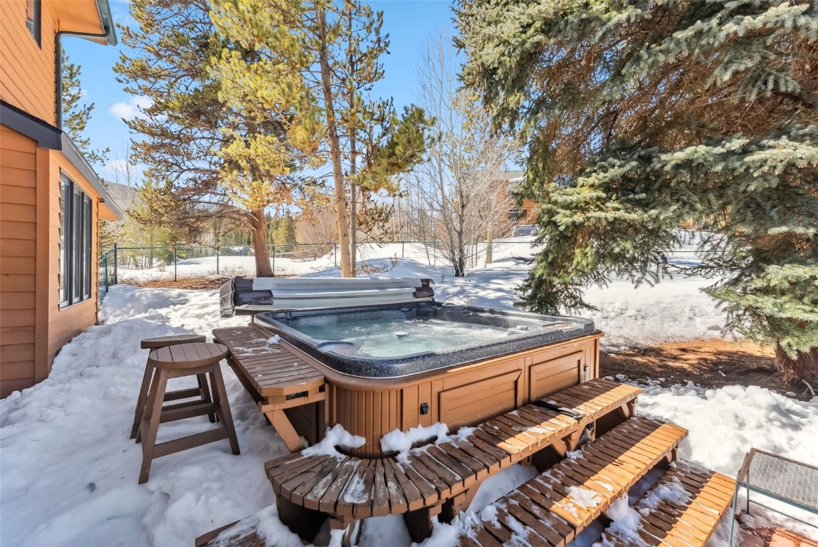 30 Grey Fox Lane Dillon, CO 80435 - Photo 46 of 50 Back patio with fire table, hot tub, picnic table, storage shed, and fenced-in yard