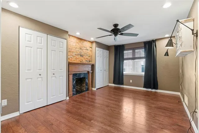 a view of an empty room with a fireplace and a window