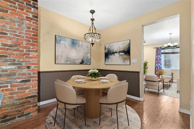 a dining room with furniture and wooden floor