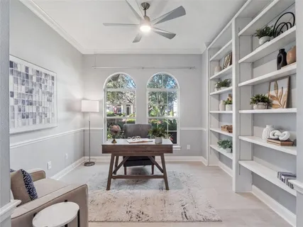 a workspace with furniture and a large window