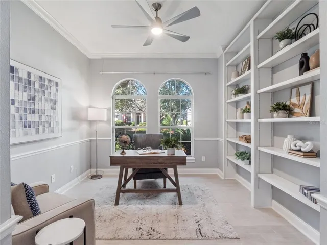 a workspace with furniture and a large window