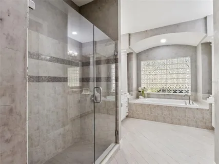 a bathroom with a bathtub and a shower
