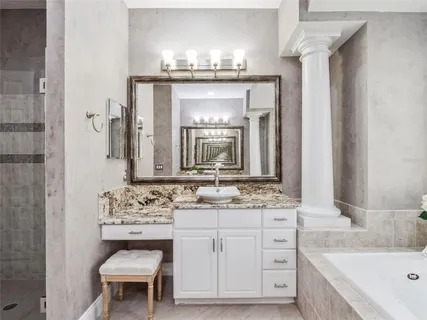 a bathroom with a sink vanity and a mirror