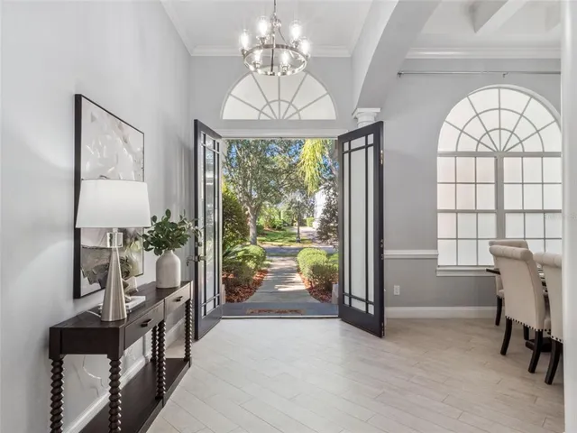 a very nice looking room with a large window and a chandelier