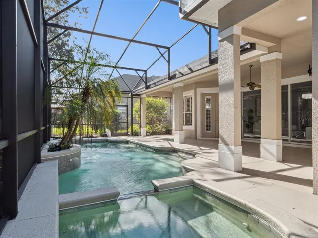 a view of a house with backyard and sitting area