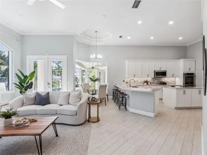 a living room with kitchen island furniture and a wooden floor