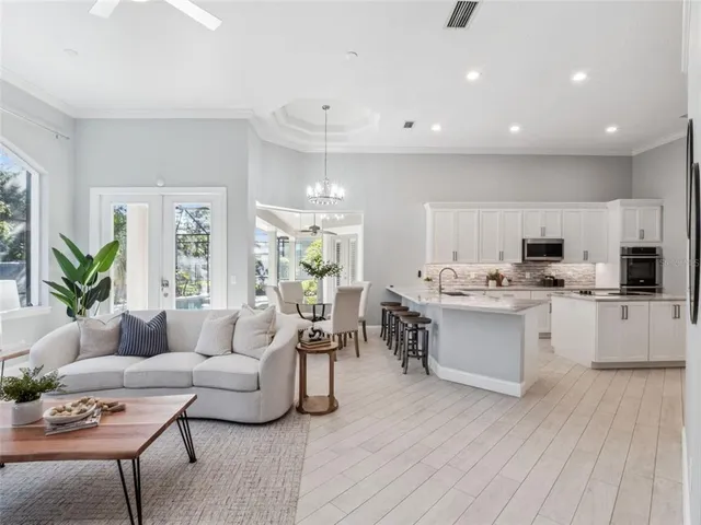 a living room with kitchen island furniture and a wooden floor