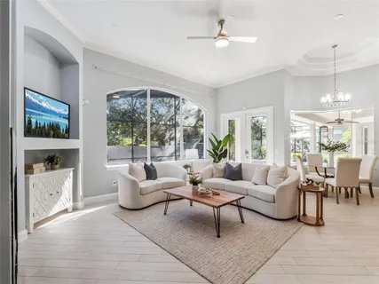 a living room with furniture and a chandelier