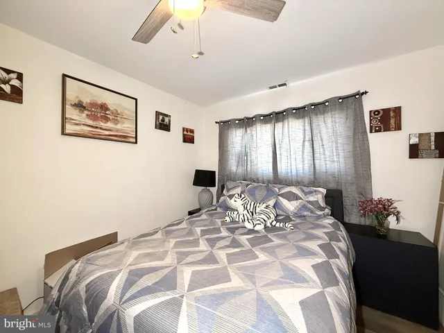 a bathroom with a sink toilet a mirror and shower curtain