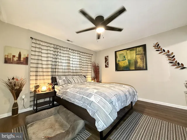 a bedroom with a bed and a painting on the wall